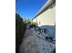 Exterior shot of home's utilities, with a stone walking path alongside house at 12184 Aztec Rose Ln, Orlando, FL 32827