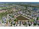 This aerial shows homes nestled in a community alongside a picturesque pond at 12613 Maribou Cir, Orlando, FL 32828
