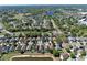 An aerial view shows the property with a pool, nestled in a neighborhood near a pond at 12613 Maribou Cir, Orlando, FL 32828