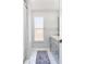 Bright bathroom showcasing a gray vanity, tile flooring, and ample natural light at 12613 Maribou Cir, Orlando, FL 32828