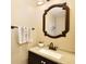 Bathroom featuring neutral-toned vanity with countertop, sink, and framed mirror at 12613 Maribou Cir, Orlando, FL 32828