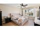 Sunlit bedroom with large window and view, features elegant bedding and furnishings at 12613 Maribou Cir, Orlando, FL 32828