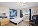 Inviting bedroom with a ceiling fan, large window, and wood-look flooring at 12613 Maribou Cir, Orlando, FL 32828