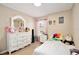 Cozy bedroom featuring a charming white dresser and decor with wood flooring at 12613 Maribou Cir, Orlando, FL 32828
