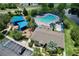 Overhead shot of community pool and playground including lounge chairs, mature trees and parking at 12613 Maribou Cir, Orlando, FL 32828