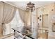 Bright dining area with table and chairs beneath an elegant chandelier at 12613 Maribou Cir, Orlando, FL 32828