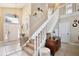 Inviting foyer features tile flooring, staircase with decorative risers, chandelier and front door with sidelights at 12613 Maribou Cir, Orlando, FL 32828