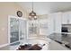 Eat-in kitchen features white cabinets, granite countertops, and a sliding door that leads to the lanai and backyard at 12613 Maribou Cir, Orlando, FL 32828