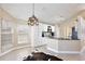 Bright eat-in kitchen with white cabinets, granite countertops, breakfast bar and view to backyard at 12613 Maribou Cir, Orlando, FL 32828