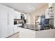 Bright kitchen featuring sleek white cabinets, striking granite countertops, and stainless steel appliances at 12613 Maribou Cir, Orlando, FL 32828
