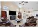 Bright and airy living room boasts a fireplace, large windows, and tile flooring, providing ample natural light at 12613 Maribou Cir, Orlando, FL 32828