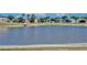 Pond view with calm water and surrounding houses at 12613 Maribou Cir, Orlando, FL 32828