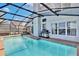 Screened-in pool area with outdoor dining and grill, perfect for entertaining and enjoying the outdoors at 12613 Maribou Cir, Orlando, FL 32828