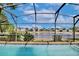 Screened pool overlooking serene lake providing an oasis for relaxation and picturesque views at 12613 Maribou Cir, Orlando, FL 32828