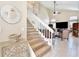 Staircase leads to the upper level and an overview of the living room with high ceilings and a ceiling fan at 12613 Maribou Cir, Orlando, FL 32828