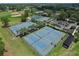 Aerial view of the community tennis courts, well-maintained and surrounded by lush landscaping and a park area at 12613 Maribou Cir, Orlando, FL 32828