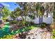 Private backyard featuring lush landscaping, stone accents, and defined pathway at 1311 Harbour Dr, Longwood, FL 32750