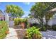 Landscaped backyard oasis with mature trees, garden beds, and a stone pathway at 1311 Harbour Dr, Longwood, FL 32750