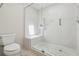 Modern bathroom featuring a glass shower with a built-in seat and stone floor at 1311 Harbour Dr, Longwood, FL 32750