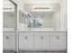 Bright bathroom featuring dual sinks, a large mirror and white shaker cabinets at 1311 Harbour Dr, Longwood, FL 32750