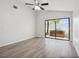 Bright bedroom featuring light wood flooring and a sliding glass door to the outdoor spa at 1311 Harbour Dr, Longwood, FL 32750