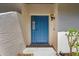 The front entrance features a sturdy blue door, a lantern, and a decorative sidelight at 1311 Harbour Dr, Longwood, FL 32750