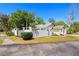 The home features a decorative fence and mature trees and landscaping at 1311 Harbour Dr, Longwood, FL 32750