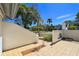The tiled patio shows a view of the front lawn behind a concrete fence at 1311 Harbour Dr, Longwood, FL 32750