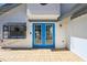 Exterior facade showing blue double doors and adjacent window at 1311 Harbour Dr, Longwood, FL 32750