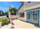 A view of the outdoor patio with blue double doors and an adjacent window at 1311 Harbour Dr, Longwood, FL 32750