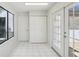 Bright hallway with tile floors leading to an outdoor patio and closet space at 1311 Harbour Dr, Longwood, FL 32750