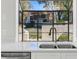 Kitchen sink area with stainless steel faucet and sink beneath a large window offering a view to the outdoors at 1311 Harbour Dr, Longwood, FL 32750