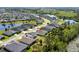 Beautiful aerial view of a residential area with lush greenery and a tranquil lake at 17668 Passionflower Cir, Clermont, FL 34714