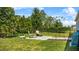 A green backyard featuring a stone paver patio and manicured landscaping at 17668 Passionflower Cir, Clermont, FL 34714