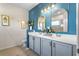 Bathroom vanity featuring double sinks, and an oversized decorative mirror at 17668 Passionflower Cir, Clermont, FL 34714