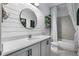 Modern bathroom featuring shiplap walls, a round mirror, and a shower-tub combo with stylish shelving at 17668 Passionflower Cir, Clermont, FL 34714