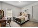 Cozy bedroom featuring a comfortable bed with patterned bedding and a quaint writing desk at 17668 Passionflower Cir, Clermont, FL 34714