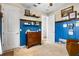 Charming bedroom with blue paneled walls, wood accents, and an antique dresser changing table at 17668 Passionflower Cir, Clermont, FL 34714