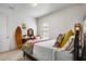 Comfortable bedroom with light carpet and walls with floral decorative touches and bright pillows at 17668 Passionflower Cir, Clermont, FL 34714