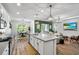 Open-concept kitchen with an island, connecting to the living and dining areas, ideal for entertaining at 17668 Passionflower Cir, Clermont, FL 34714