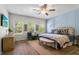 A spacious main bedroom with lots of natural light and neutral colored decor at 17668 Passionflower Cir, Clermont, FL 34714