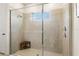 Beautiful tiled shower with glass door and a convenient corner seat at 17668 Passionflower Cir, Clermont, FL 34714