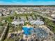 An aerial view of the community pool and clubhouse area shows ample parking and well-maintained facilities at 1807 Good Neighbor Loop, Kissimmee, FL 34744