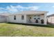 The home's backyard features a covered patio, a grassy area and a privacy fence at 1807 Good Neighbor Loop, Kissimmee, FL 34744