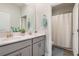 Bathroom featuring double sinks, gray cabinetry, and a separate shower area at 1807 Good Neighbor Loop, Kissimmee, FL 34744