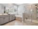 Bathroom featuring a dual vanity, soaking tub, and separate glass-enclosed shower at 1807 Good Neighbor Loop, Kissimmee, FL 34744