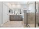 Bright bathroom features a double vanity, a large mirror and a walk-in shower at 1807 Good Neighbor Loop, Kissimmee, FL 34744