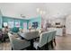Bright dining area features an open floorplan with a kitchen view, a modern light fixture, and stylish furniture at 1807 Good Neighbor Loop, Kissimmee, FL 34744
