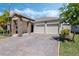 Paver driveway and walkway leading to the entry of a well-maintained home with a two-car garage at 1807 Good Neighbor Loop, Kissimmee, FL 34744