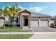 Charming single-story home featuring stone accents, manicured landscaping, and a convenient two-car garage at 1807 Good Neighbor Loop, Kissimmee, FL 34744